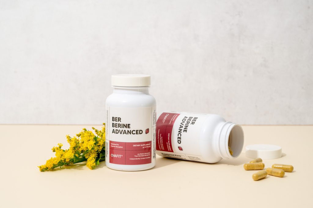 Berberine supplement Berberine supplement bottles with flowers and pills spilled over